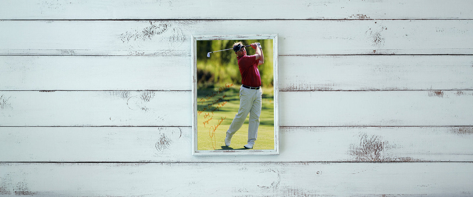 Golfer swinging a club on a golf course.