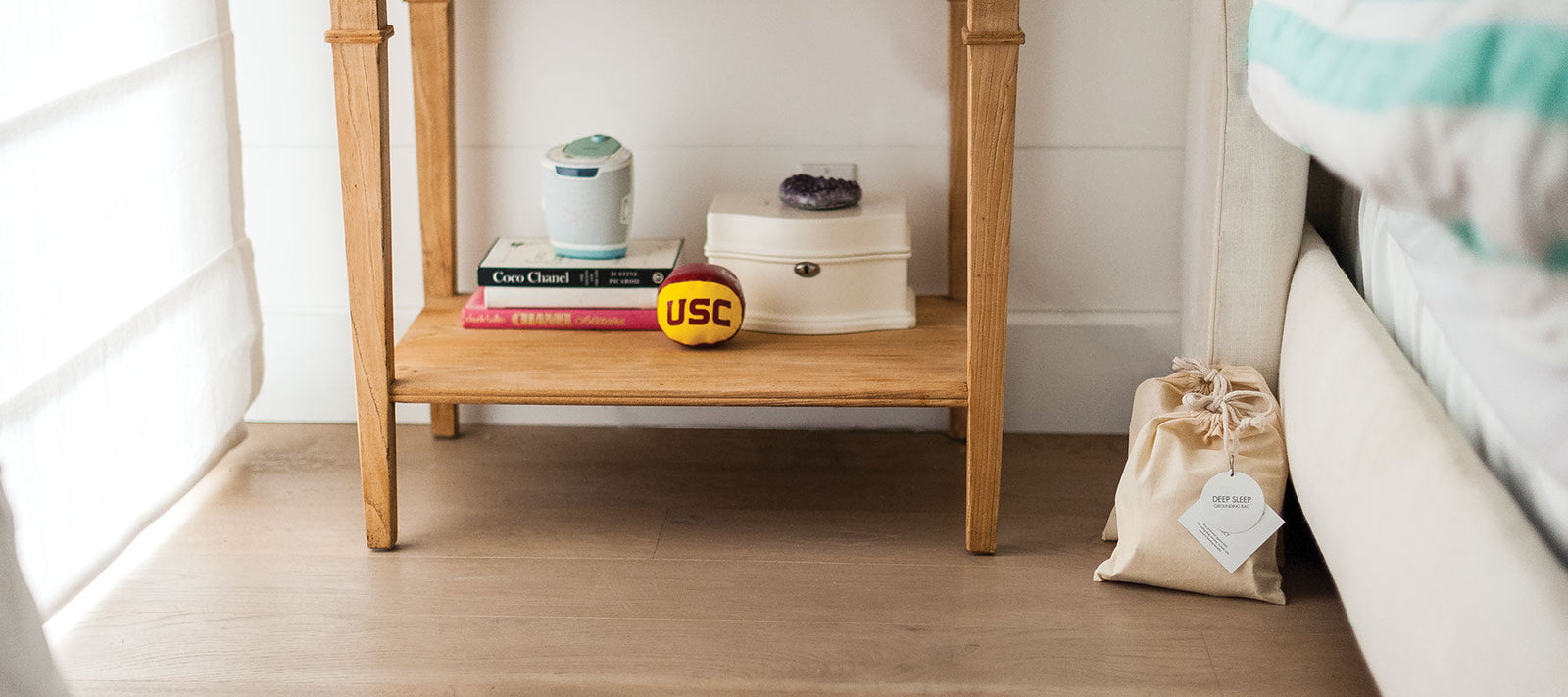 EMF Rocks Grounding Bag on bed providing natural, native EMF protection using hand-mined crystals and earth's Schumann Resonance for sleep