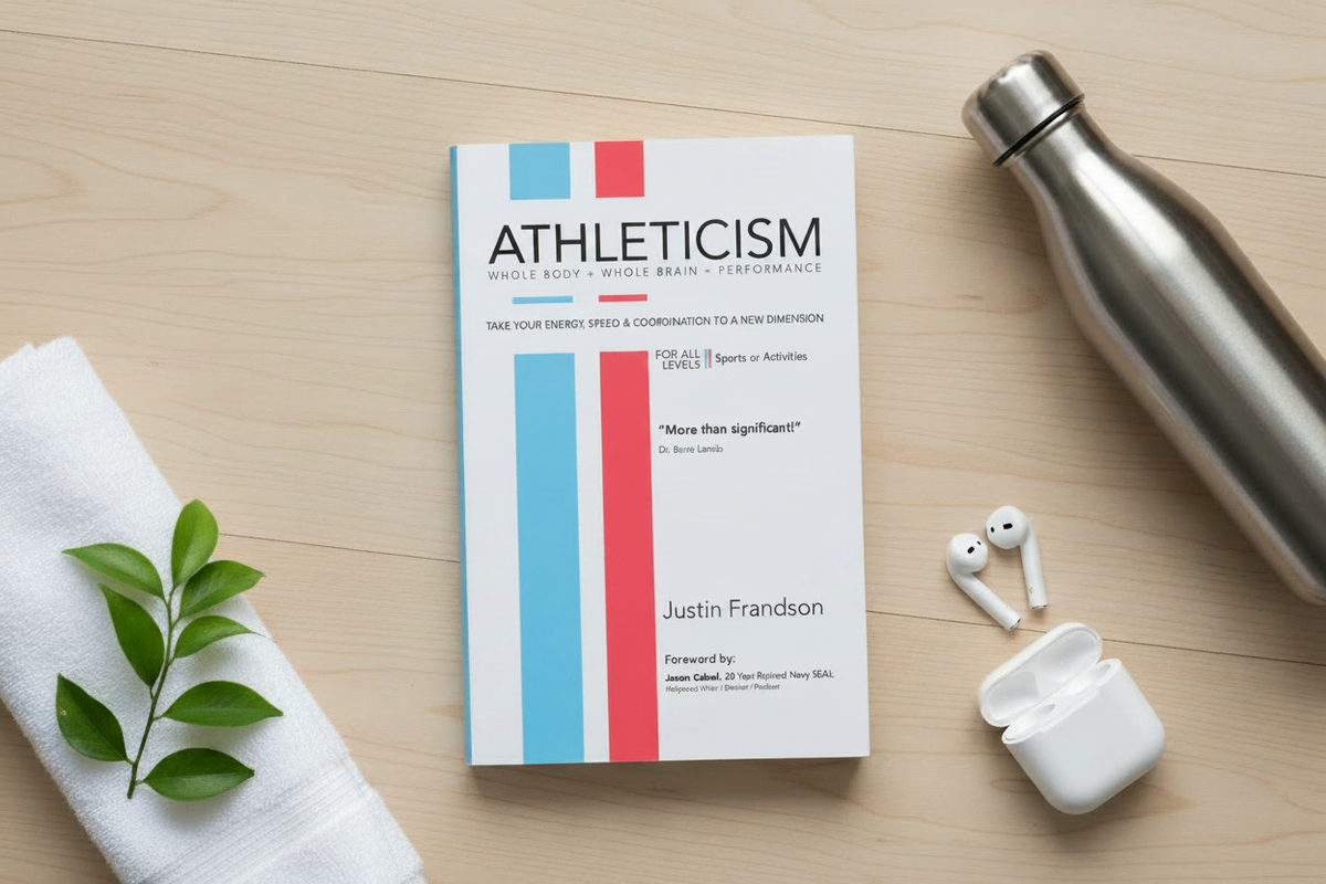 Athleticism softcover book by Justin Frandson in a lifestyle flat lay on a gym floor with water bottle and athletic props